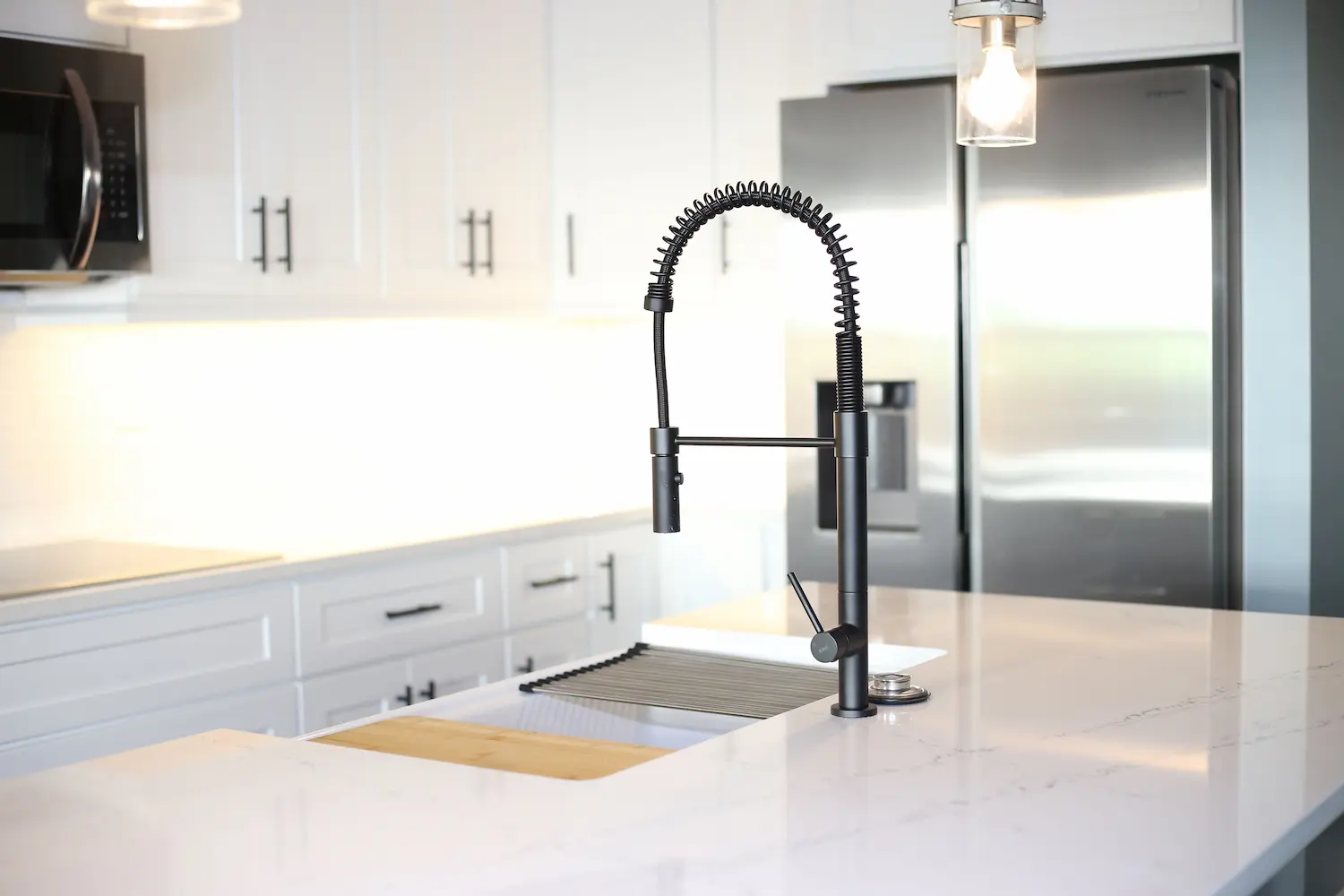 Mooresville kitchen with white shaker cabinets and quartz waterfall island